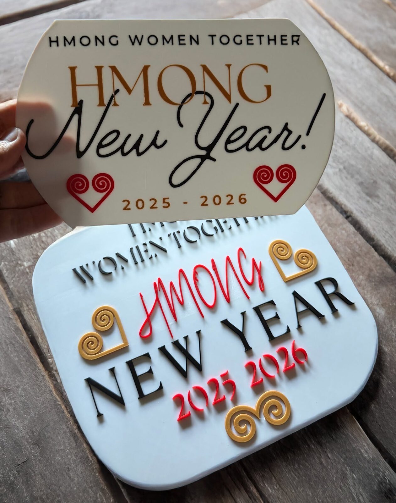 Custom 3D-printed Hmong New Year signage made for Hmong Women Together, with traditional motifs and the year